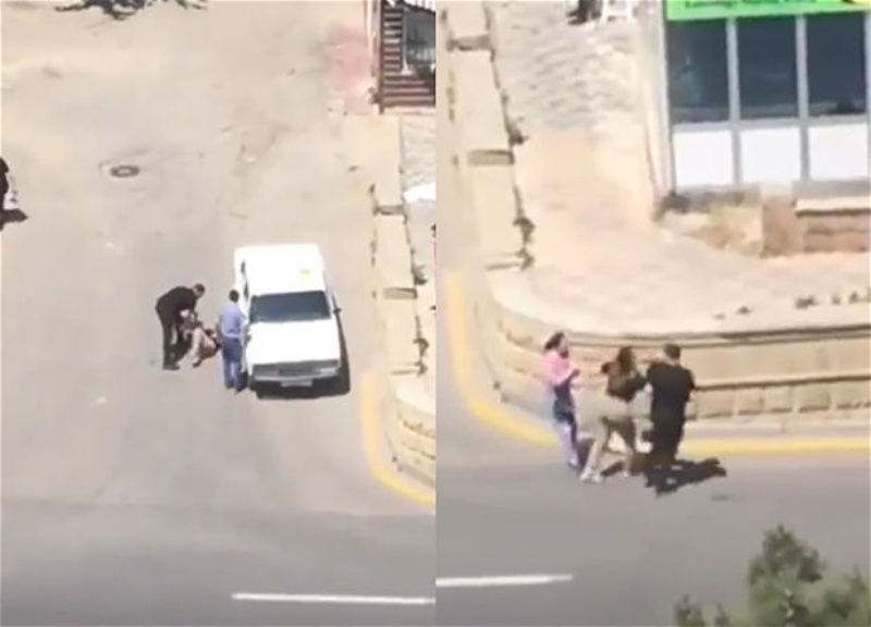 В Баку женщина пытается сбежать от преследующего ее водителя, прохожие не реагируют и просто наблюдают - ВИДЕО